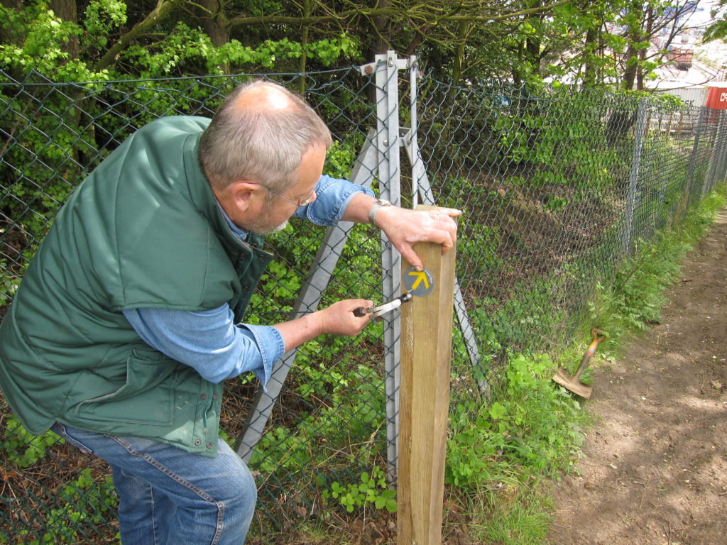 Volunteer assembling a route sign