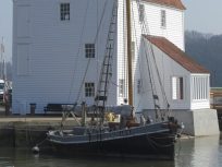 View of Tide Mill with boat in foreground