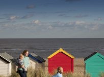 Woman and children in front of beach houses
