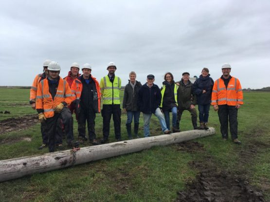 Workers standing by last removed pole