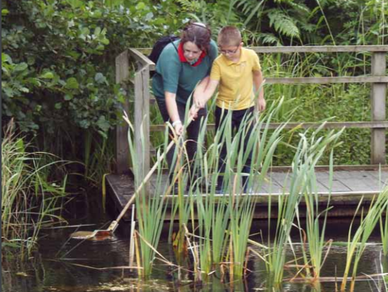 A photo of the front cover of the autism visitor guide showing a young boy and a lady