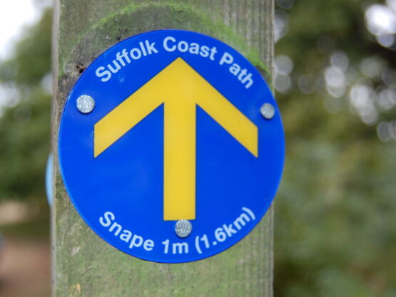 A close-up of a Suffolk Coast Path Waymark Disc